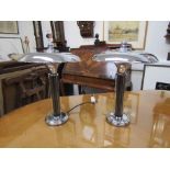 A pair of Art Deco style chrome table lamps of UFO design, domed shades,