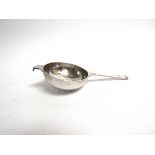 A silver tea strainer London 1945,