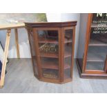 An Edwardian mahogany counter top display cabinet with painted advertising glass panels,