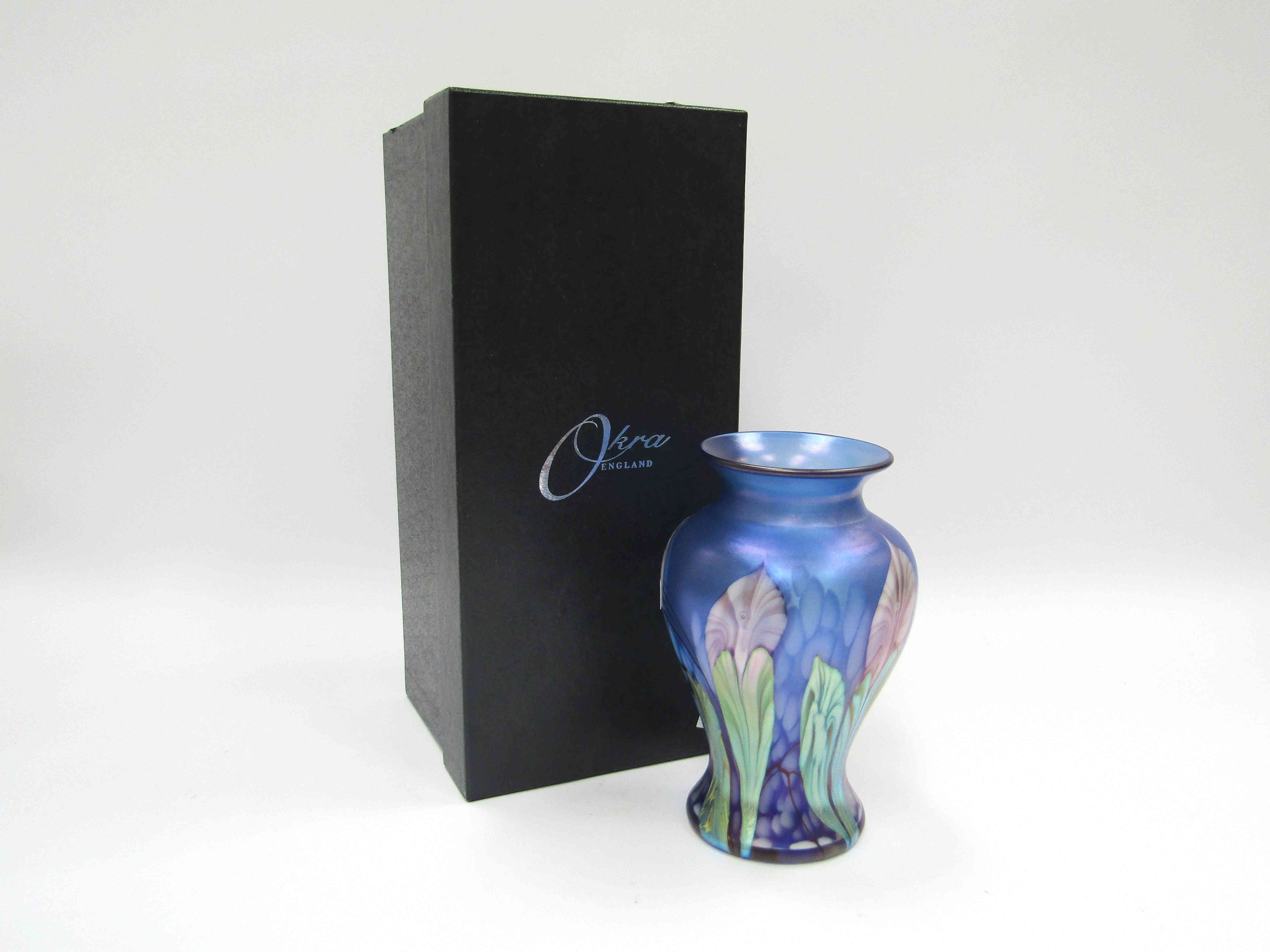 An Okra glass vase designed by Dave Barras, blue with iridescent floral detail.