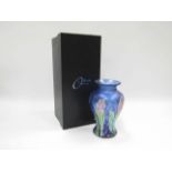 An Okra glass vase designed by Dave Barras, blue with iridescent floral detail.