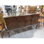 An early to mid 20th Century walnut sideboard with glass top,