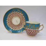 A Sevres 19th Century twin handled cup with saucer, with peacock decoration,