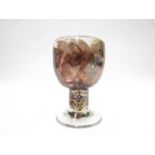ANNETTE MEECH (b.1948): A studio glass goblet with iridescent brown and blue swirls.