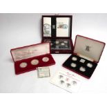 Three proof coin sets including Royal Mint 1984-1987 £1 silver proof collection.