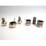 Two silver three piece cruet sets, pierced example,