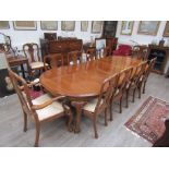 A mahogany 9' (fully extended) dining table with three removable leaves and a set of twelve chairs
