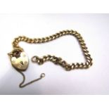 A 9ct gold curb link bracelet with padlock clasp, 17.5cm long, 12.