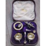 A cased pair of Victorian silver footed salts together with spoons, teething ring and rattle,
