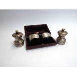 A pair of Roberts & Dore silver napkin rings (case a/f) Birmingham 1937 and an MC Herset & Sons