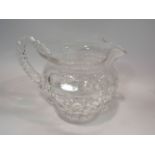 A crystal glass jug with flared rim