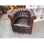 A vintage leather button back tub chair,