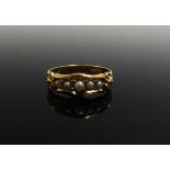 An 18ct gold ring set with five pearls in ornate setting. Size N, 3.