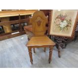 A 19th Century oak shield back hall chair