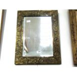 An ornate brass framed wall mirror