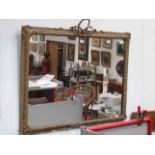 A pair of ornately gilt and gesso framed wall mirrors with ribbon detail,