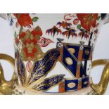A German Imari style footed vase with bird decoration (hairlined), 26.
