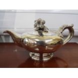 A Victorian silver teapot, oversized floral knop and foliate relief handle, marks rubbed,