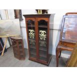 A Victorian mahogany advertising cabinet with painted advertising glass panels,