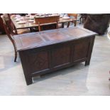 An 18th Century carved oak coffer, carved panel front, candle box to interior,