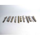 Ten various needle and pencil holders of varying designs and age,