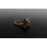 A gold ring with ruby trefoil and diamond trefoil set in a twist, 18ct gold. Size M, 2.