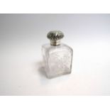 A perfume bottle with sterling silver top,