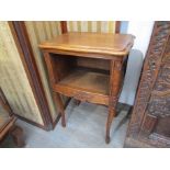 A French oak bedside cabinet with carved decoration on cabriole legs