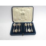 A Harrods Ltd silver coffee spoon and tongs set, monogrammed, London 1929,