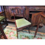 A William IV mahogany chair with brass line inlay and carved decoration over sabre legs