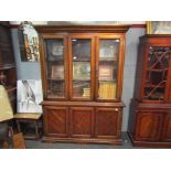 A glazed wooden cabinet with three shelves over three cupboards,