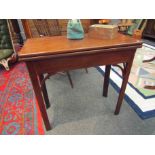 A mahogany tea table with arched supports,
