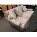A 20th Century three seater sofa with floral upholstery