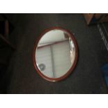 An inlaid mahogany oval inlaid wall mirror