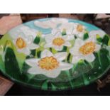 A garden glass bowl bird bath with painted daffodil design,