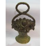 A brass foliate flat back door stop