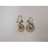 A pair of gold earrings,