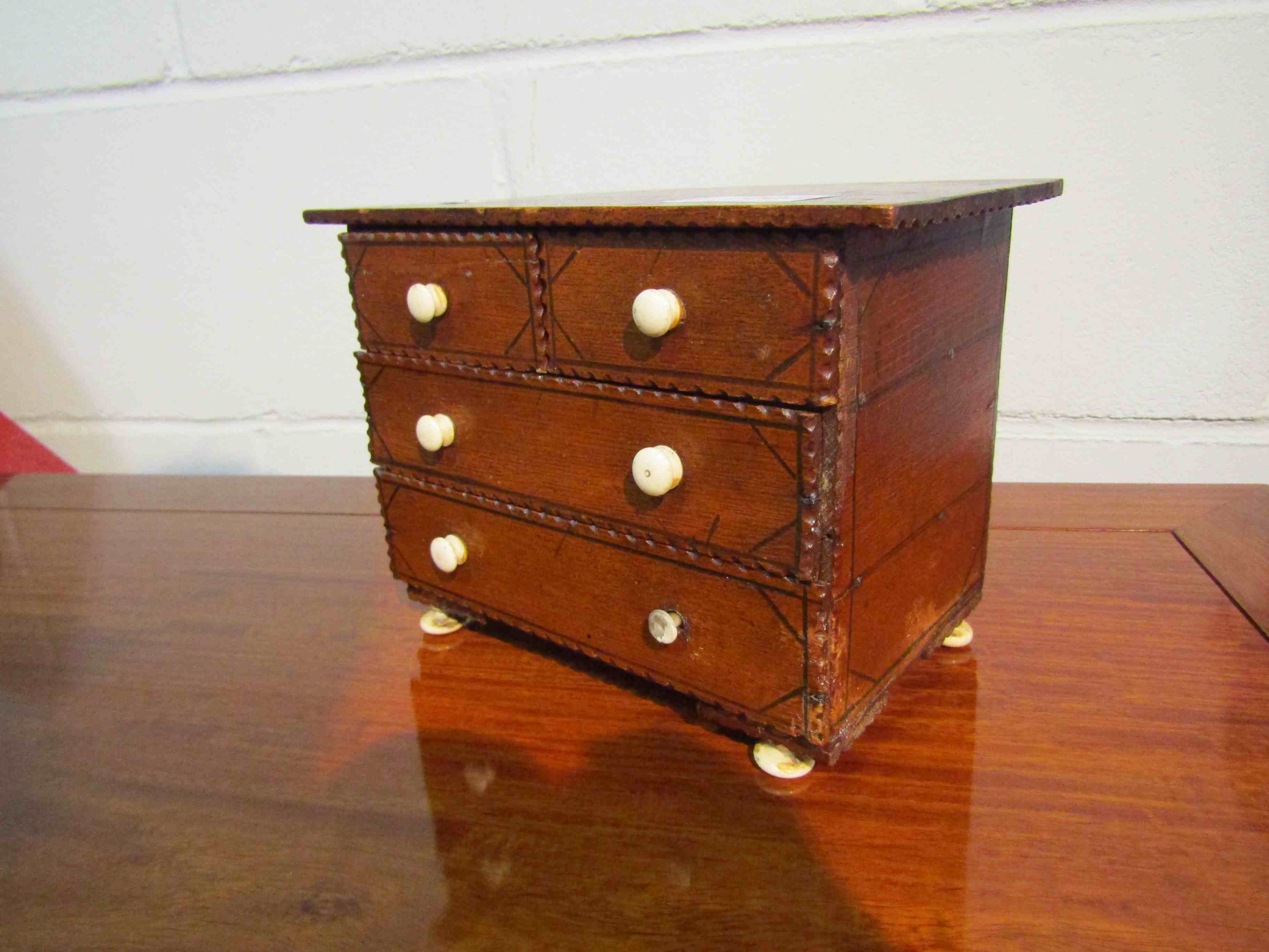 An apprentice miniature two over and chest of drawers