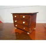 An apprentice miniature two over and chest of drawers