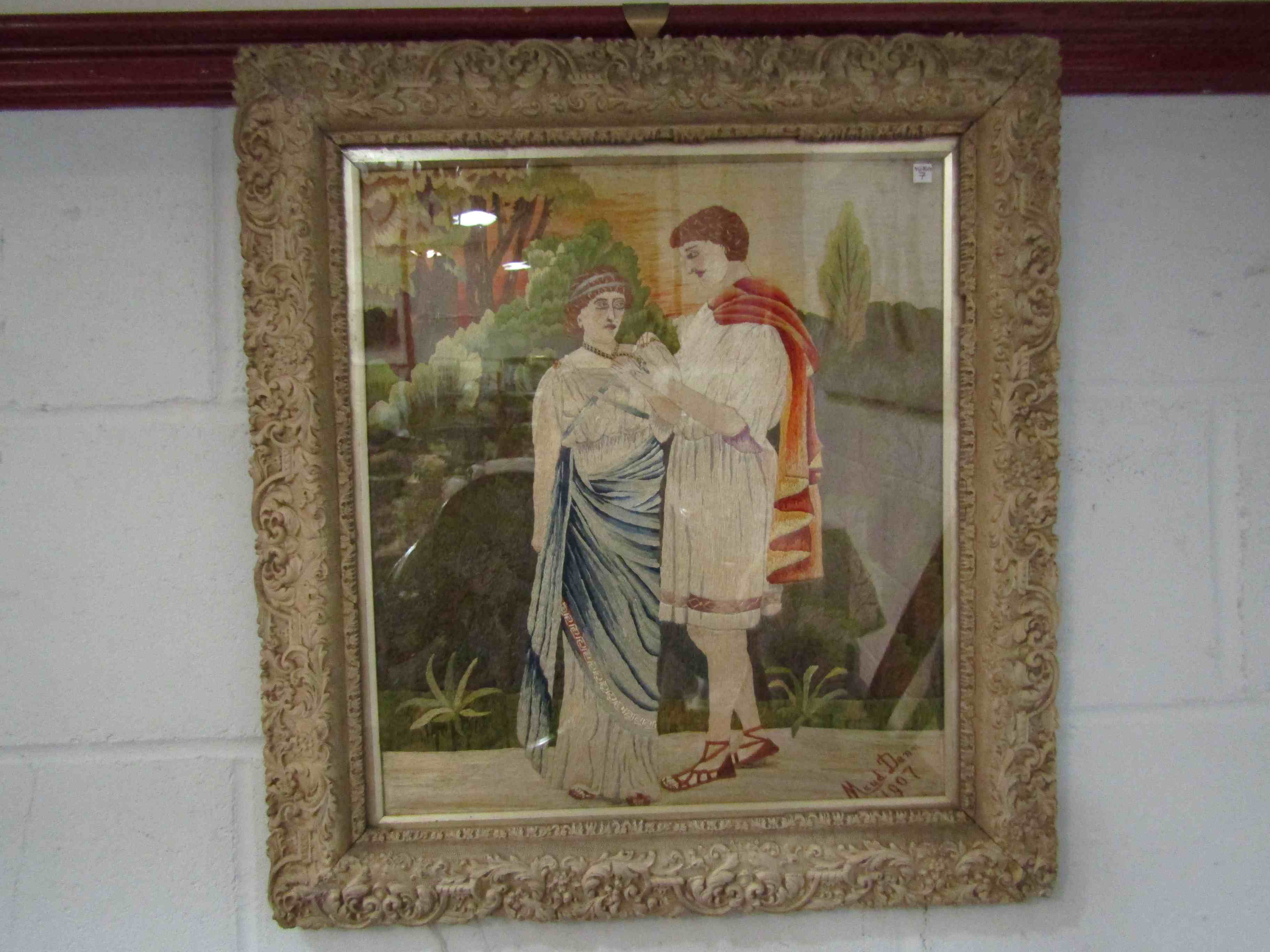 MAUD DANN 1907: Framed and glazed silk work depicting Roman era lovers,