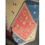 A multi-coloured geometric Kilim rug,