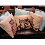 Nine cushions, four depicting cats in costume etc.