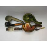 A Meerschaum pipe in case and two other pipes and double ended perfume bottle