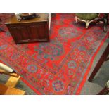 A blood red ground large carpet, multiple motifs and borders,