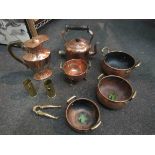 A cast iron cauldron, copper pans,