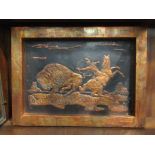A hammered metal image of a native American on horseback hunting a buffalo,