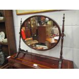 An Edwardian oval table top swing mirror