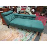 A late Victorian/early Edwardian chaise longue with green swag upholstery on ring turned legs to