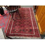 A red ground geometric rug,