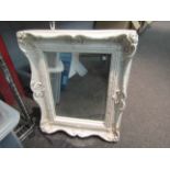 A white framed modern wall mirror,